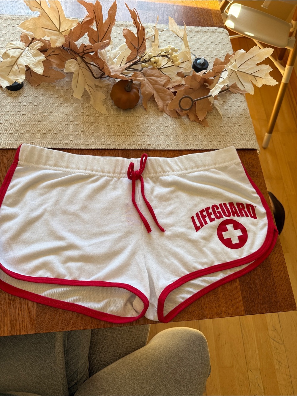 Lifeguard Women's White Athletic Jersey Shorts with Red Trim.